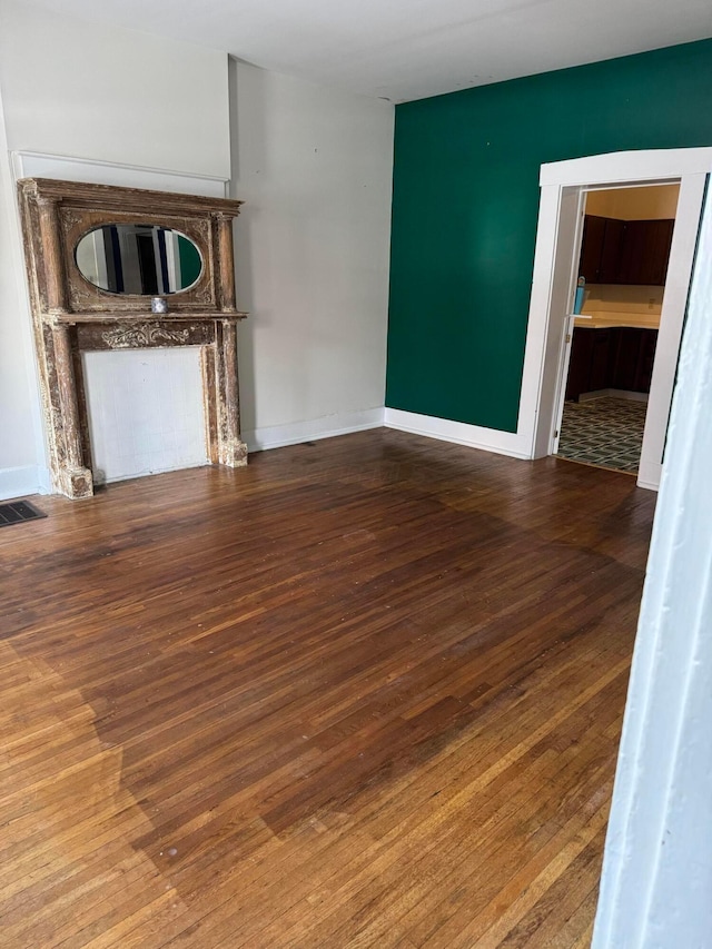 unfurnished living room with hardwood / wood-style flooring