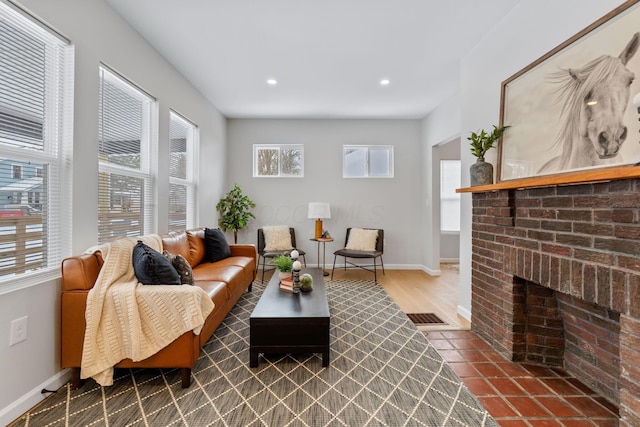 living room with a brick fireplace