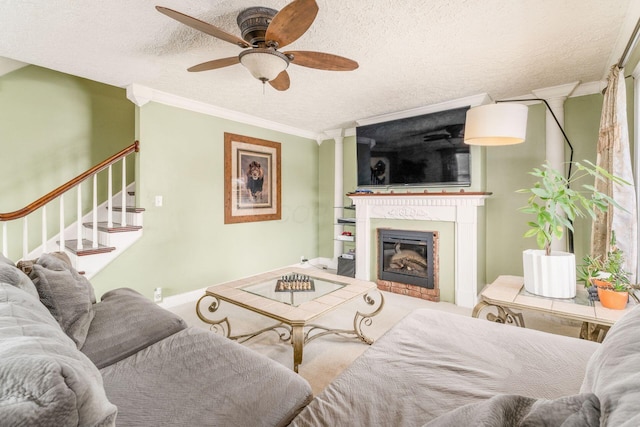 living room featuring ceiling fan, crown molding, and a textured ceiling