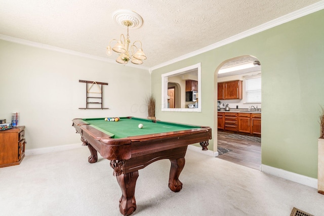 game room featuring sink, pool table, light colored carpet, a textured ceiling, and ornamental molding