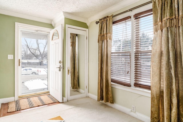 doorway with light carpet, a textured ceiling, and ornamental molding