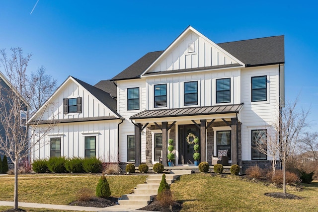 modern farmhouse with a front yard, a standing seam roof, covered porch, board and batten siding, and metal roof