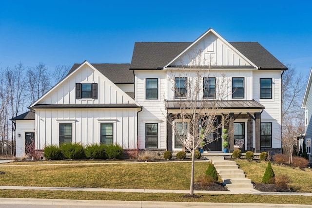 modern inspired farmhouse featuring a porch, roof with shingles, board and batten siding, and a front yard