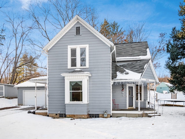 view of front of house with a garage, an outbuilding, and a trampoline