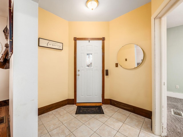 foyer entrance featuring light tile patterned flooring