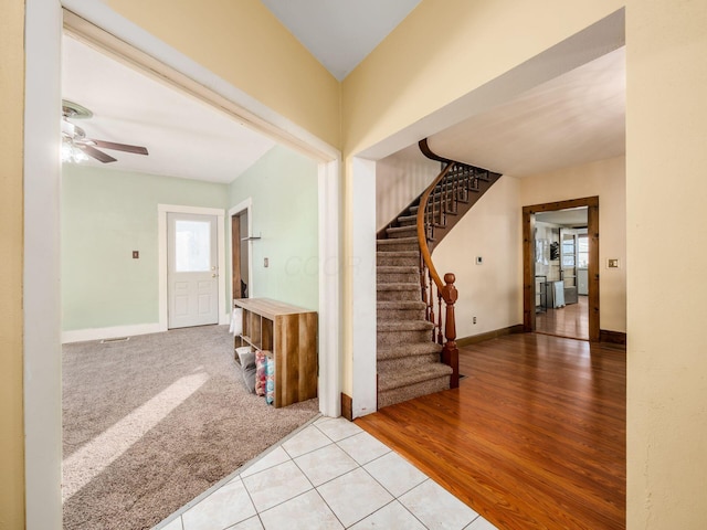 entrance foyer with light tile patterned flooring and ceiling fan