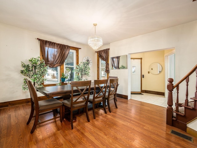 dining room featuring a notable chandelier and light hardwood / wood-style floors