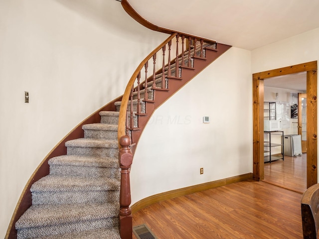 stairway featuring wood-type flooring