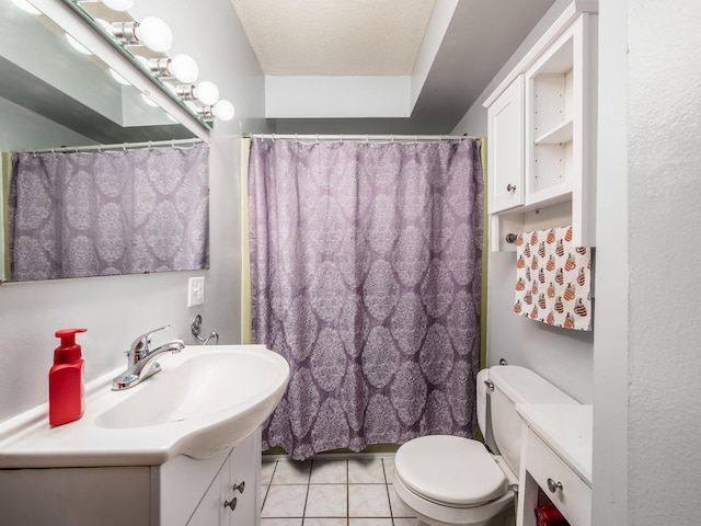 bathroom featuring toilet, a textured ceiling, walk in shower, tile patterned floors, and vanity