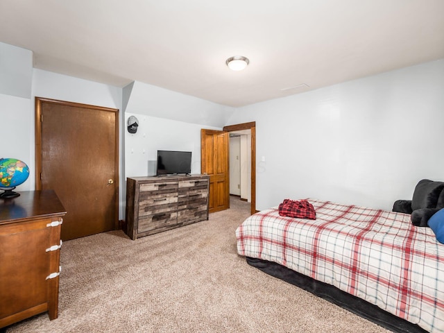 bedroom with light carpet, a closet, and vaulted ceiling