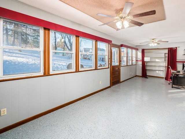 interior space with a textured ceiling and ceiling fan