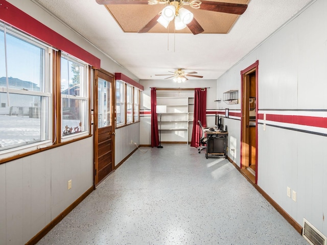 interior space featuring ceiling fan