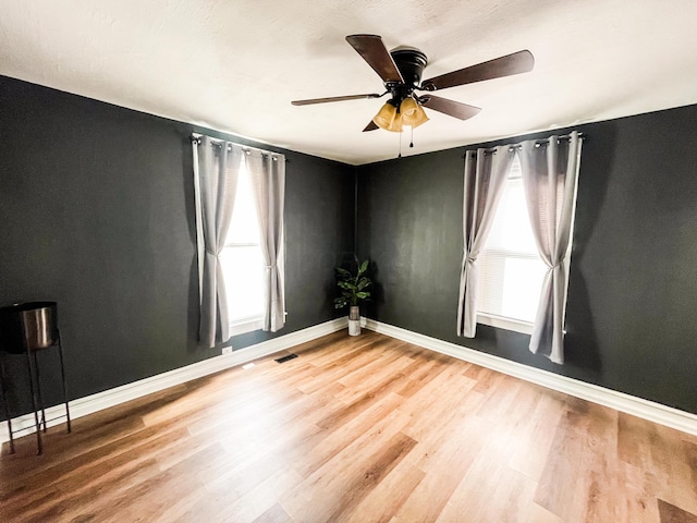 spare room featuring ceiling fan and hardwood / wood-style flooring