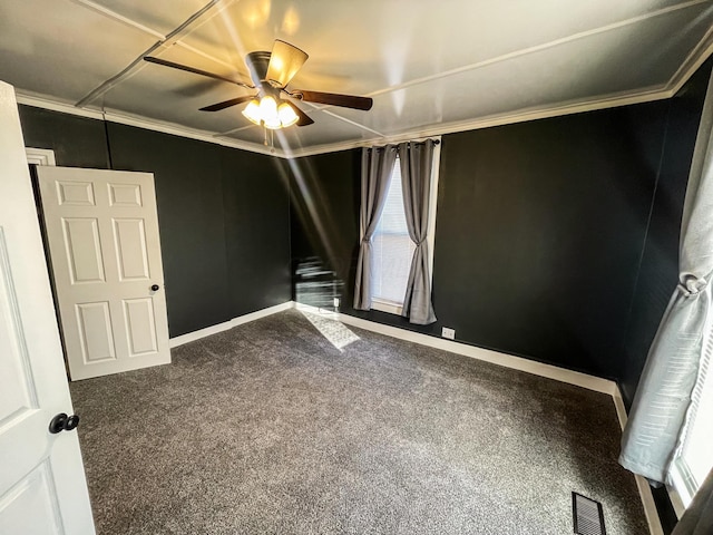 carpeted empty room featuring ceiling fan and ornamental molding