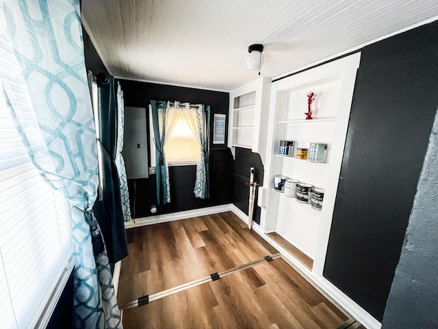 entryway with built in shelves and wood-type flooring