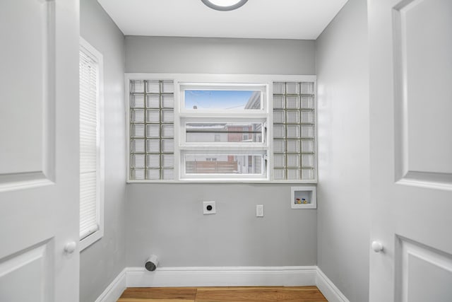 laundry area with hookup for an electric dryer, hookup for a washing machine, and hardwood / wood-style flooring