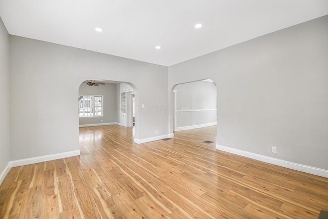 spare room featuring ceiling fan and light hardwood / wood-style flooring