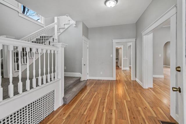 bedroom featuring light wood-type flooring and a nursery area