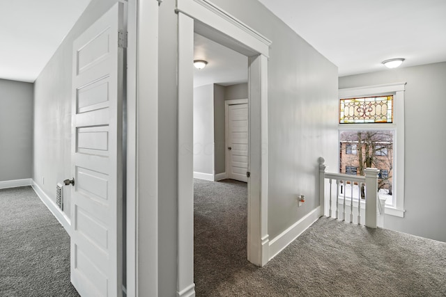 hallway featuring dark carpet