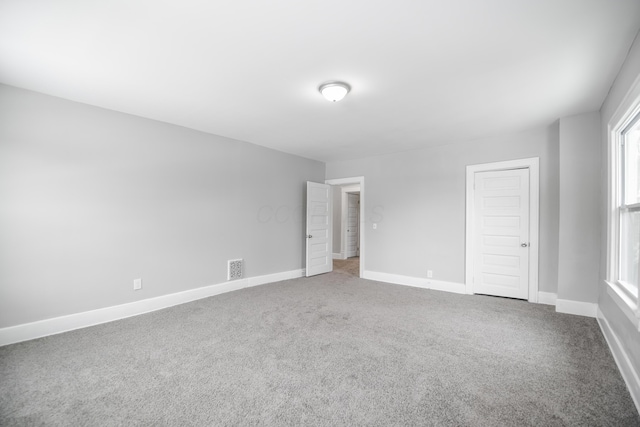 unfurnished bedroom featuring carpet flooring and a closet