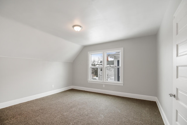 bonus room with lofted ceiling and carpet floors