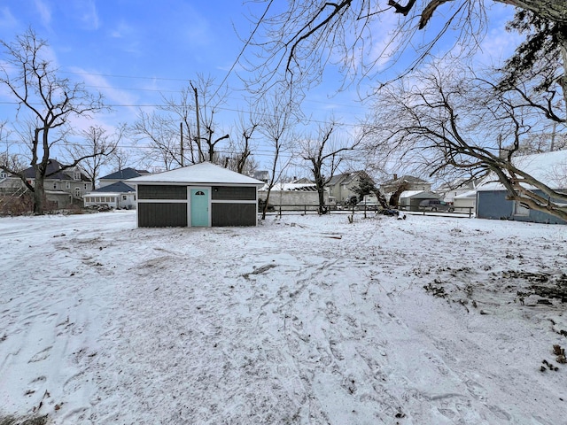 yard covered in snow featuring an outdoor structure