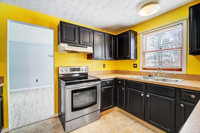 kitchen with sink, a textured ceiling, and stainless steel range with electric cooktop