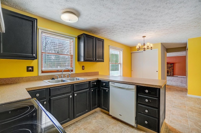 kitchen with sink, hanging light fixtures, kitchen peninsula, a chandelier, and white dishwasher