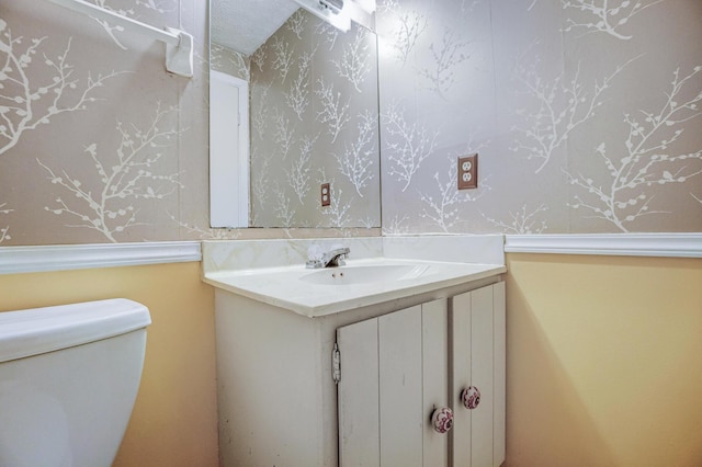 bathroom featuring toilet and vanity