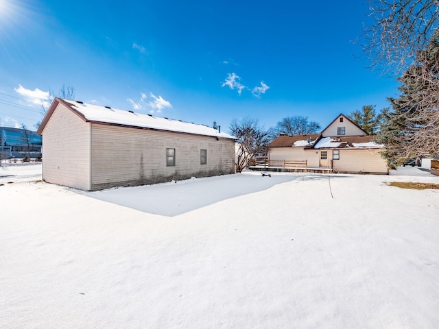 view of snow covered rear of property