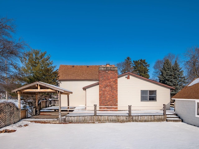 view of snow covered back of property