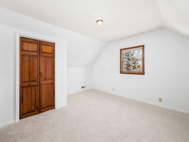 bonus room featuring light colored carpet and lofted ceiling