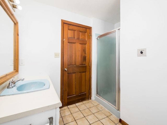 bathroom featuring an enclosed shower, vanity, and tile patterned floors