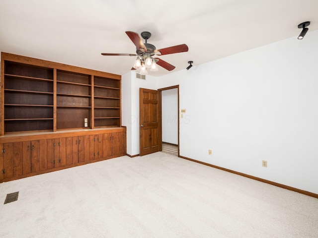 interior space featuring ceiling fan and light carpet