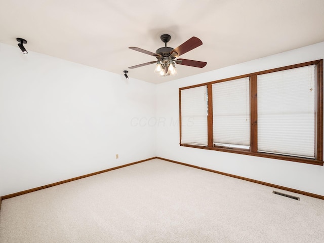 unfurnished room featuring ceiling fan and carpet flooring