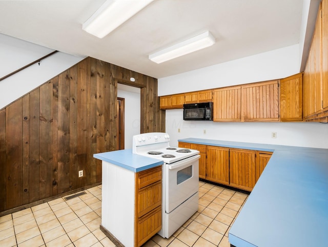 kitchen with light tile patterned flooring, wood walls, and white electric stove