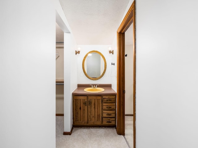 bathroom featuring a textured ceiling and vanity