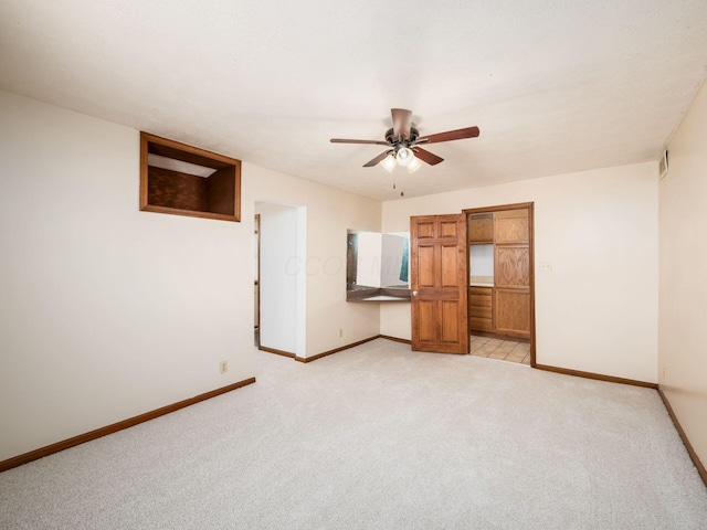 unfurnished bedroom featuring ceiling fan and light carpet