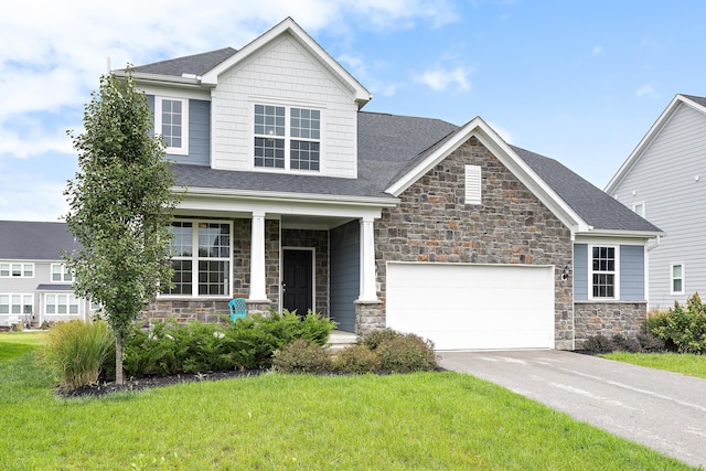 craftsman-style home featuring a front yard and a garage