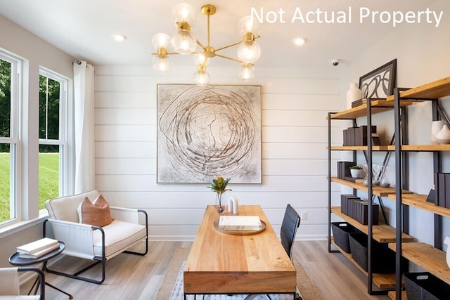 dining space with a wealth of natural light, a notable chandelier, recessed lighting, and wood finished floors