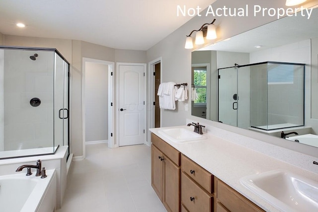 bathroom featuring a stall shower, double vanity, a sink, and a bath