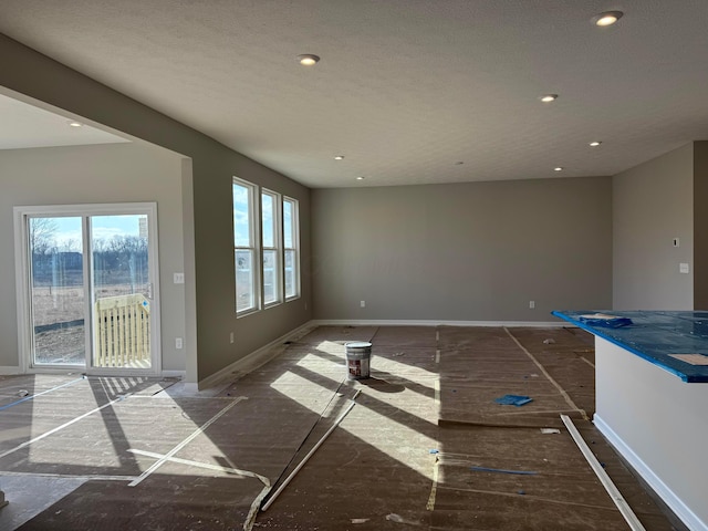 interior space featuring recessed lighting and baseboards