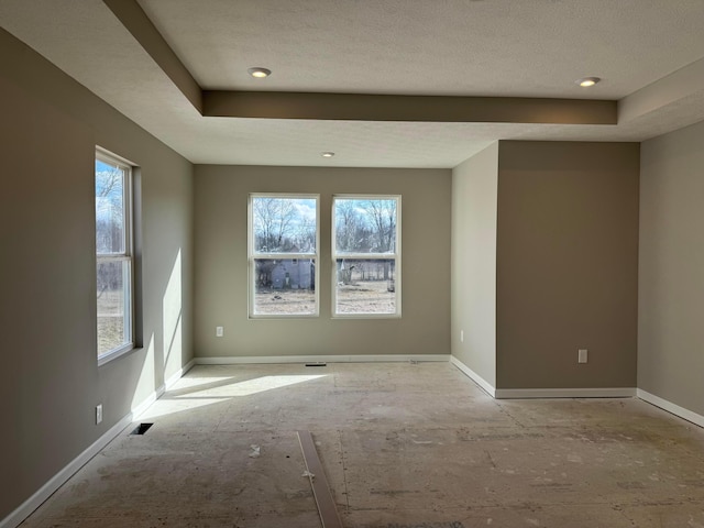 spare room with plenty of natural light and baseboards