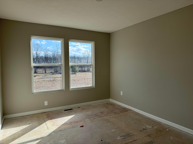 spare room with visible vents and baseboards