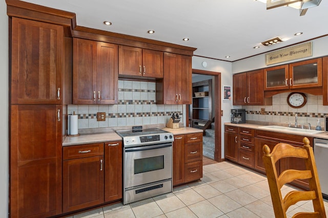 kitchen featuring backsplash, light tile patterned flooring, sink, and stainless steel appliances