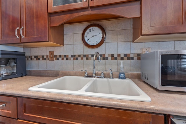 kitchen featuring decorative backsplash and sink