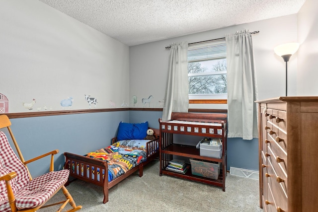 bedroom featuring carpet and a textured ceiling