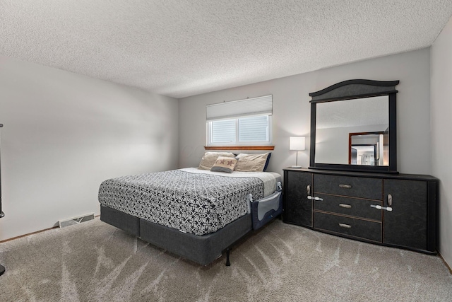 carpeted bedroom with a textured ceiling