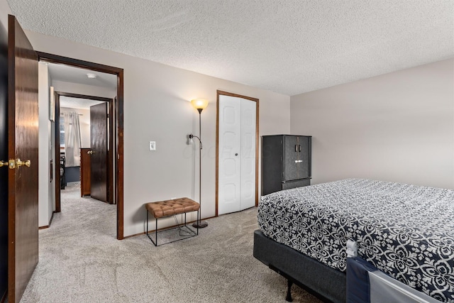 carpeted bedroom featuring a textured ceiling