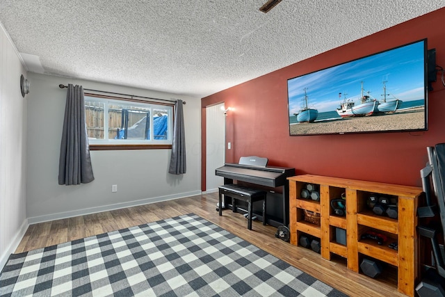 interior space with hardwood / wood-style flooring and a textured ceiling